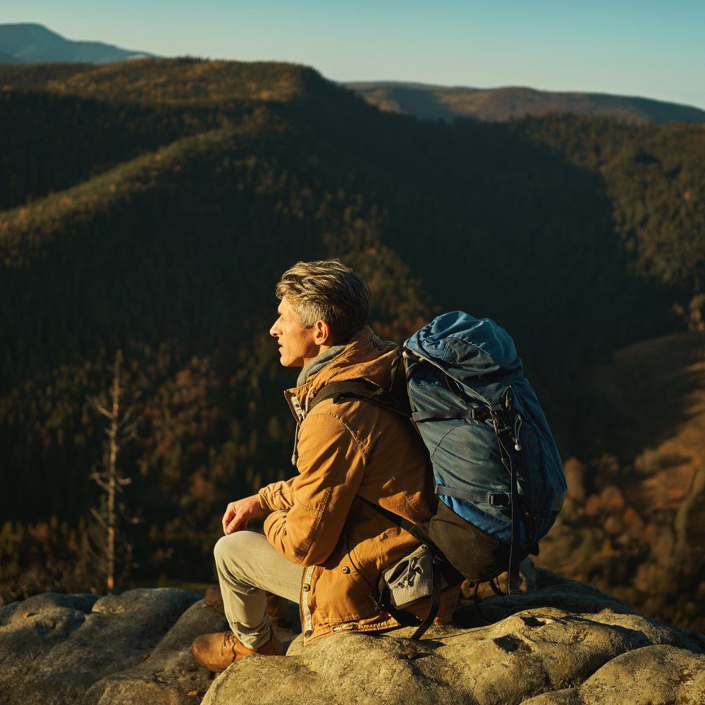 A man sitting on mountain top