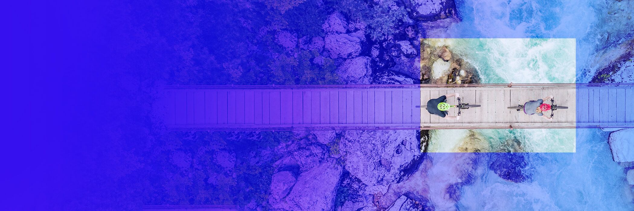 Two bikers on a bridge